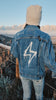 Levi Jacket. Trucker jacket with unlearn patch. stresse collective brand. mental health apparel. Mountain in backgroud