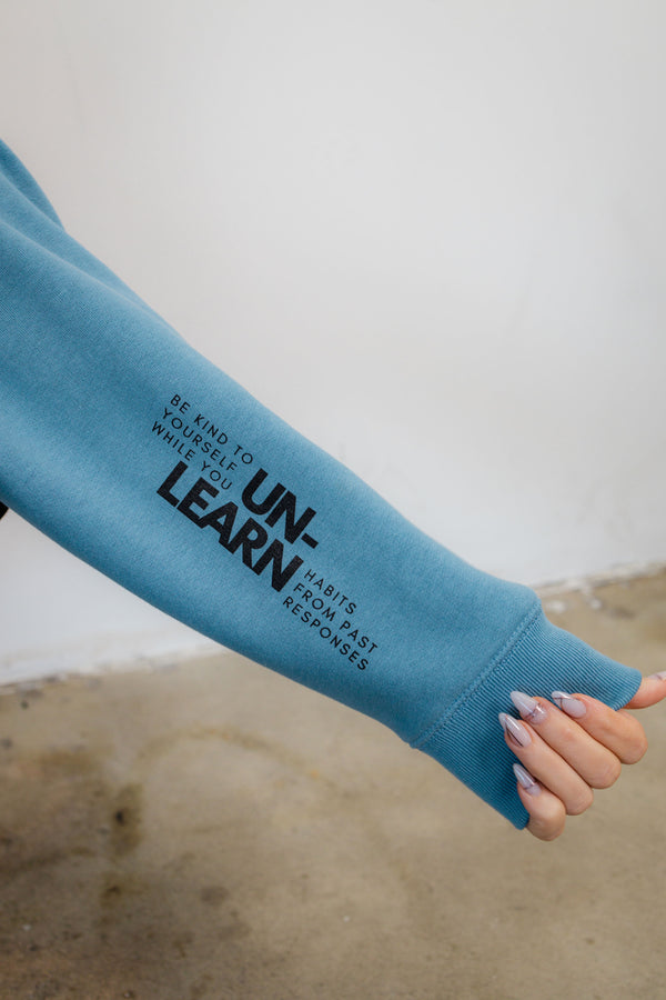 Mental health apparel. Therapy hoodie with therapy as graphics. Unlearn Sleeve view
